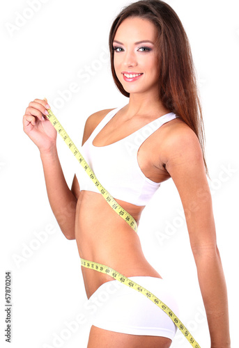 Beautiful young woman measu...