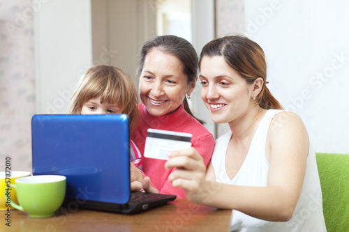 Happy family  paying by credit card in internet