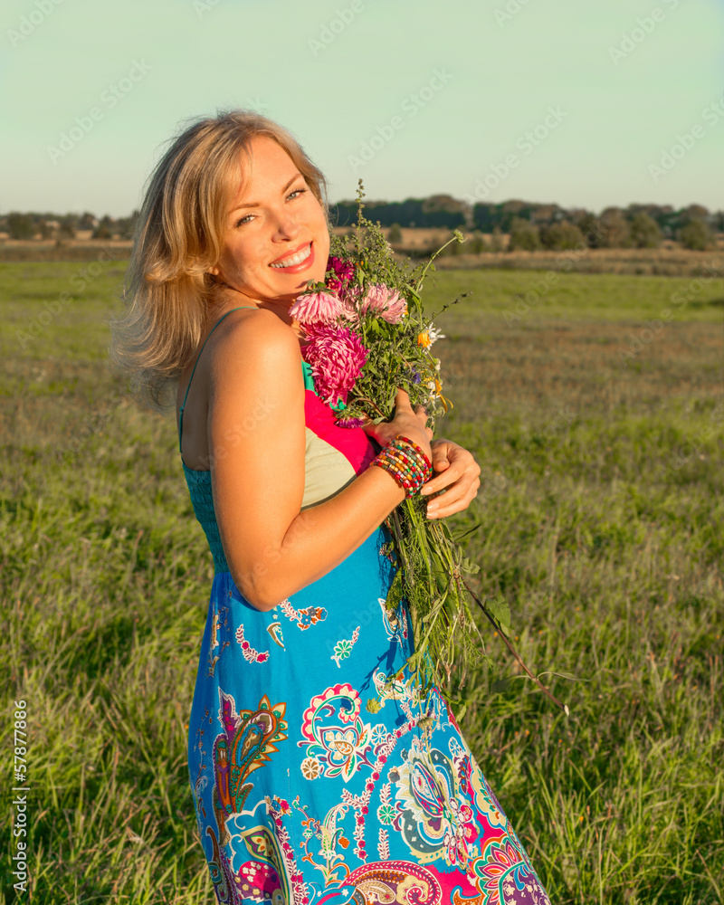 Woman with wild flowers smiling Woman with wild flowers smiling