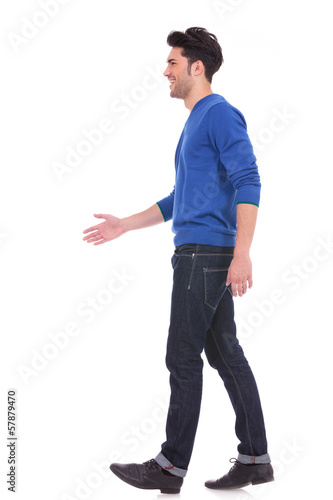 casual man in blue jeans and shirt walking