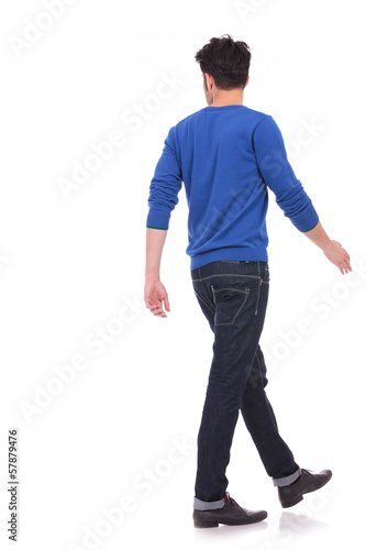 back view of a walking casual man looking to a side
