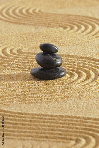Japanese zen garden with stacked stones in sand
