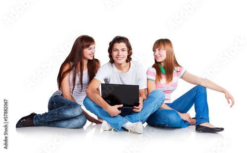 three students and laptop