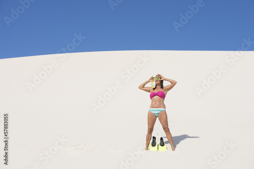 Active retired woman on beach sand dune