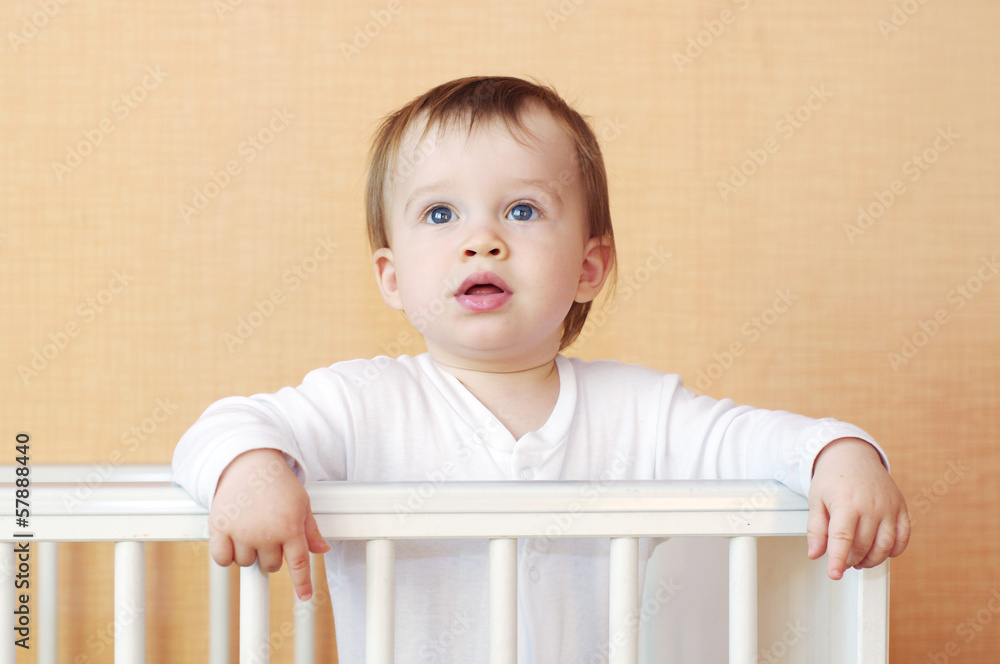 lovely baby in white bed at home lovely baby in white bed at home