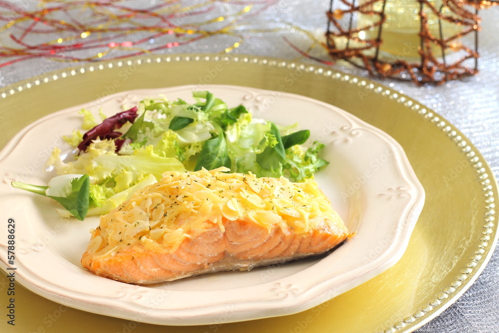 Baked salmon with almond and cheese crust on a Christmas table Baked salmon with almond and cheese crust on a Christmas table