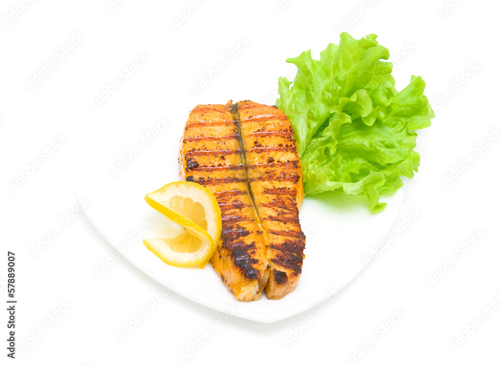 Baked trout, lemon and lettuce on a white background Baked trout, lemon and lettuce on a white background