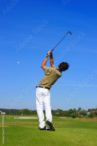 Golf, teenager golfer striking the ball