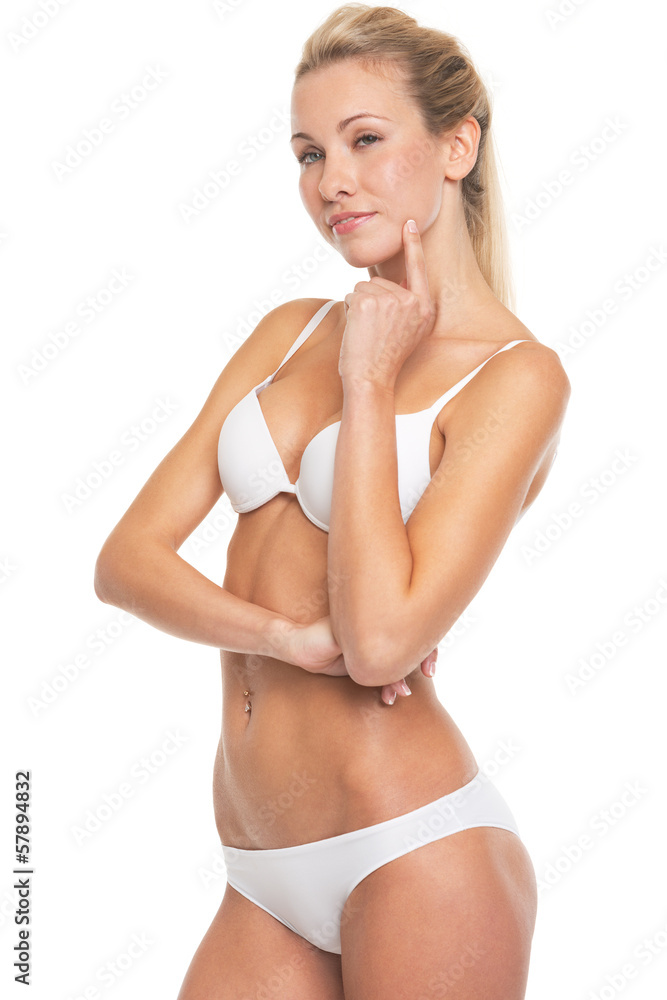 Fototapeta premium Portrait of thoughtful young woman in lingerie
