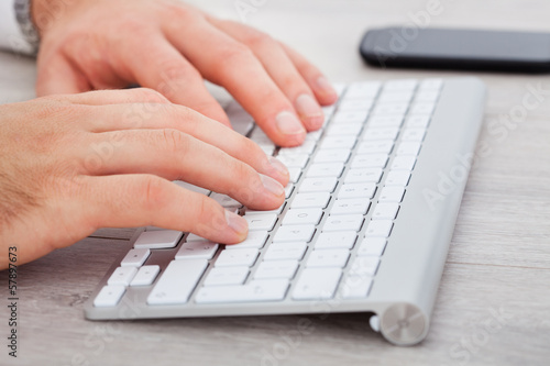 Male Hand Typing On Keyboard