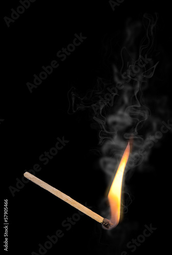 A lit match. Isolated on a black background