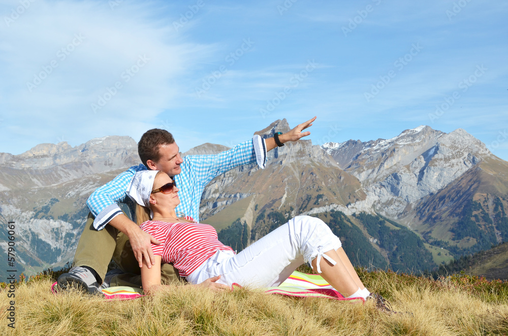 A couple enjoying Alpine panorama. Switzerland