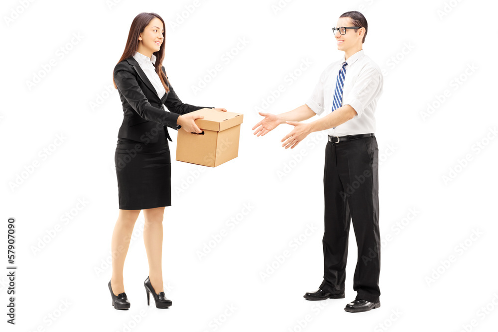 Young businesswoman giving a box to her colleague Young businesswoman giving a box to her colleague