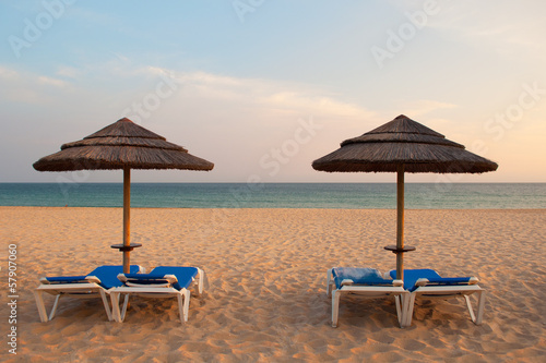 Empty deck loungers in the beach at sunset. Algarve  Portugal