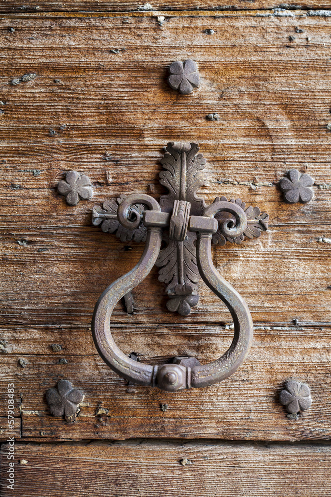 Door with decorative nails on wooden door consumed Door with decorative nails on wooden door consumed