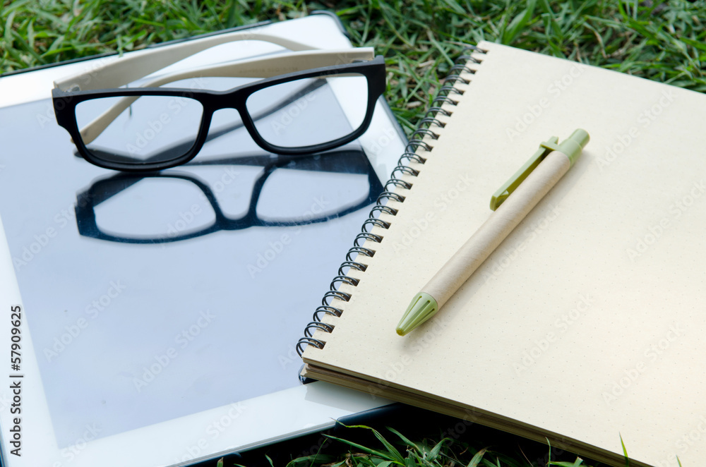 Office supplies Notebook paper tablet and glasses Office supplies Notebook paper tablet and glasses