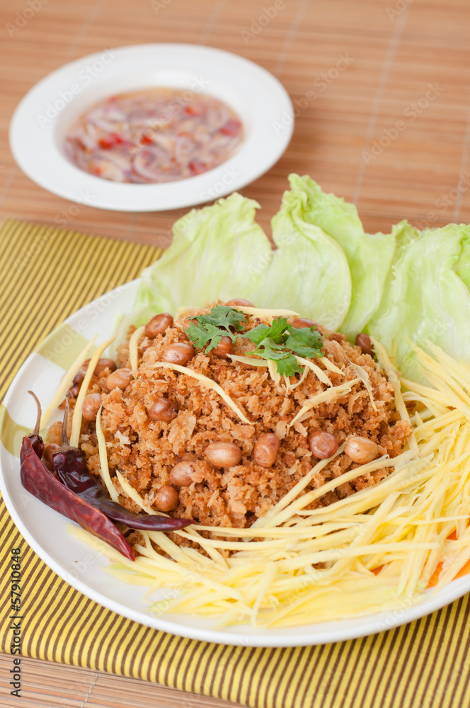 Crispy catfish with green mango salad, popular food in Thailand. Crispy catfish with green mango salad, popular food in Thailand.