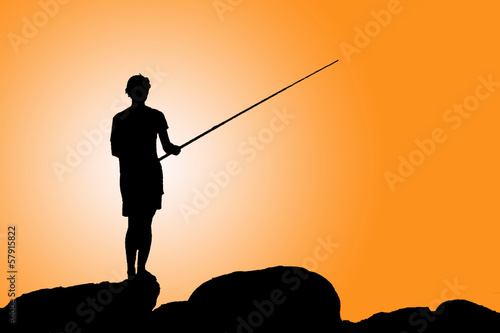 Silhouette of a man fishing