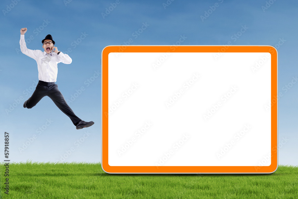Happy businessman jumping with blank board Happy businessman jumping with blank board