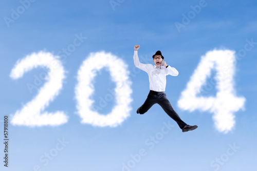 Happy businessman jumping with 2014