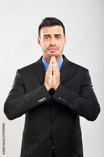 Businessman praying in supplication