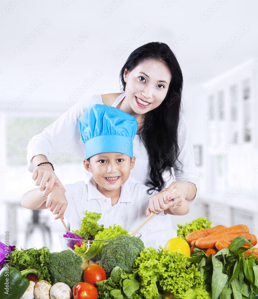 Mother and son cooking vegetable salad Mother and son cooking vegetable salad