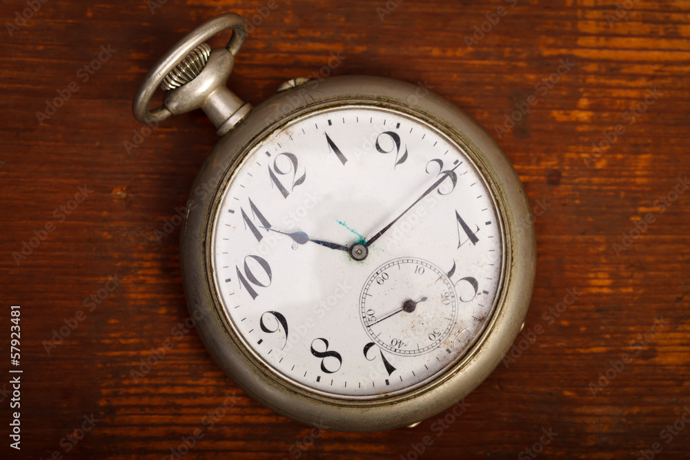 Pocket watch on wood table Pocket watch on wood table