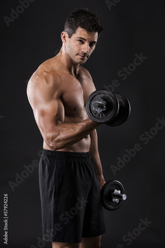 Muscular man lifting weights