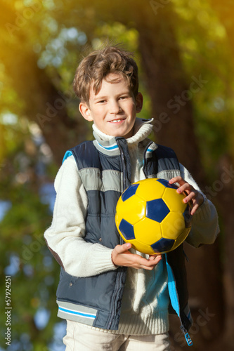 The young boy holds ball for soccer © anrymos