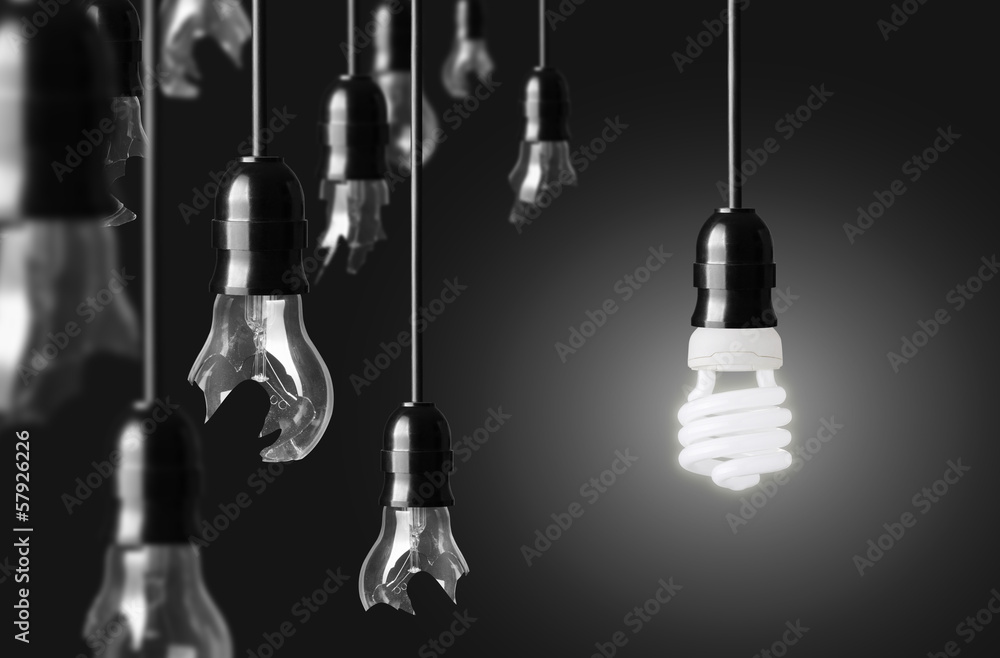 idea concept with broken bulbs and one glowing bulb - obrazy, fototapety, plakaty 