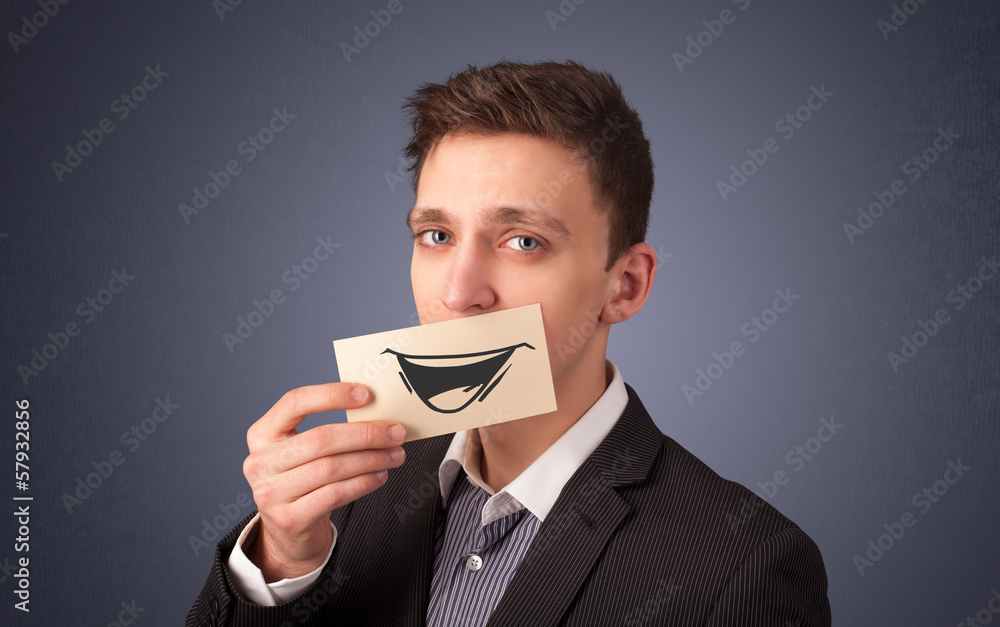 Happy businessman holding funny white card on his mouth Happy businessman holding funny white card on his mouth