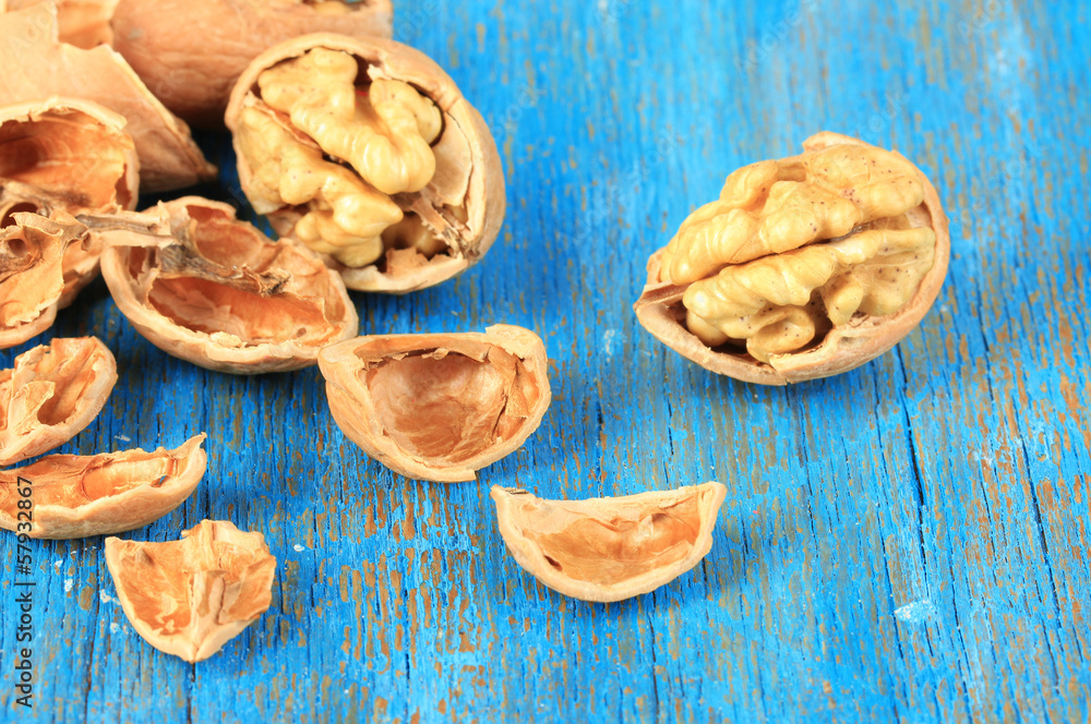 Broken walnuts on wooden table close-up Broken walnuts on wooden table close-up
