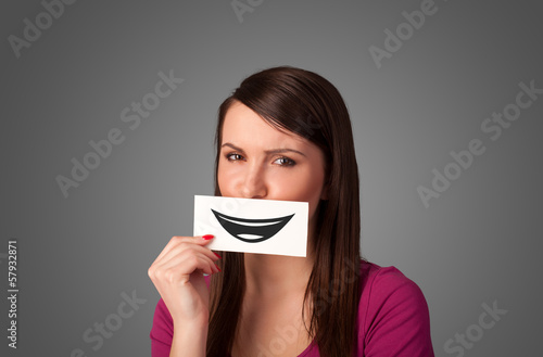 Happy pretty woman holding card with funny smiley