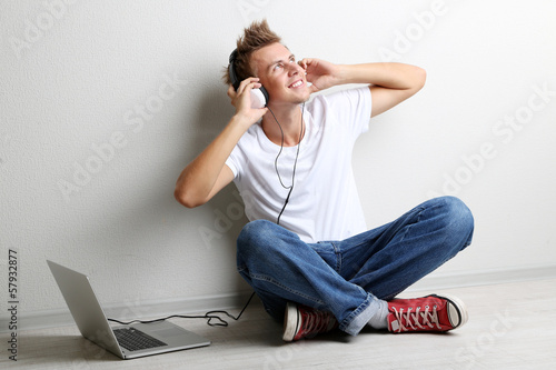 Handsome young man listenin...
