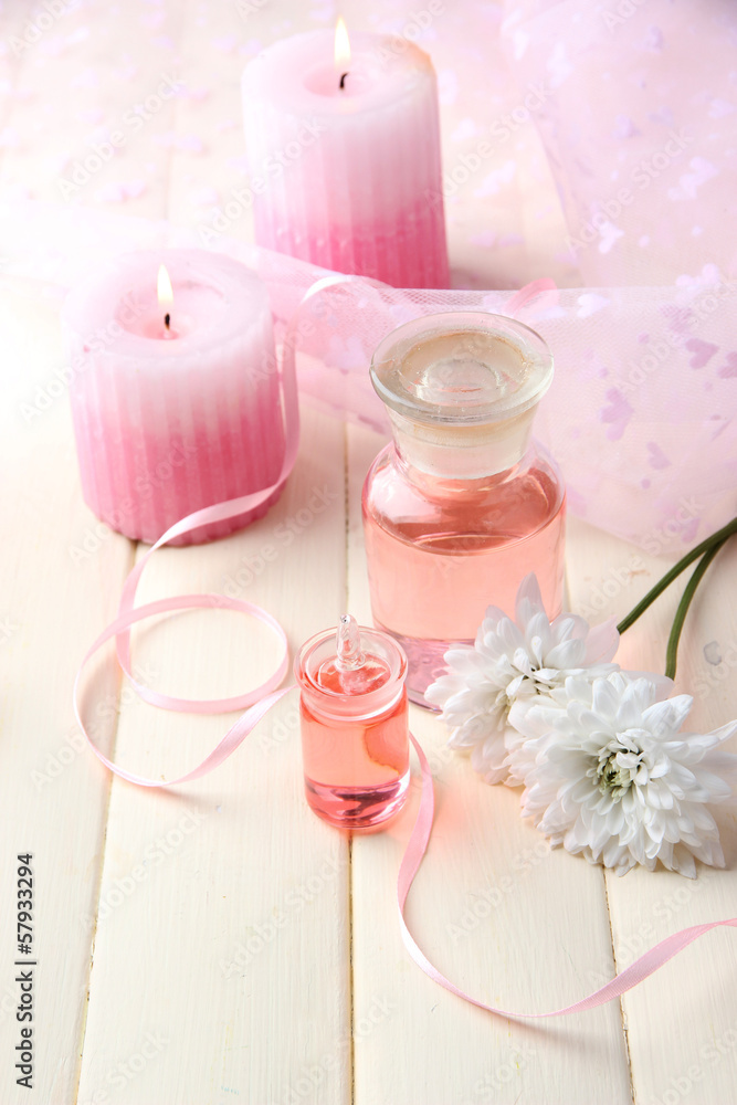 Glass bottle with color essence, on wooden background Glass bottle with color essence, on wooden background