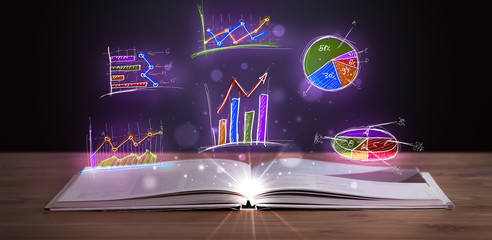 Book on wooden deck with glowing graph illustrations