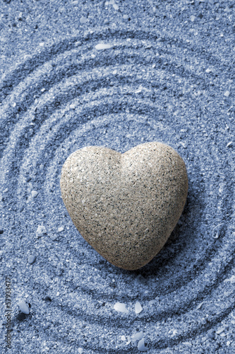 Canvas Print Grey zen stone in shape of heart, on sand background