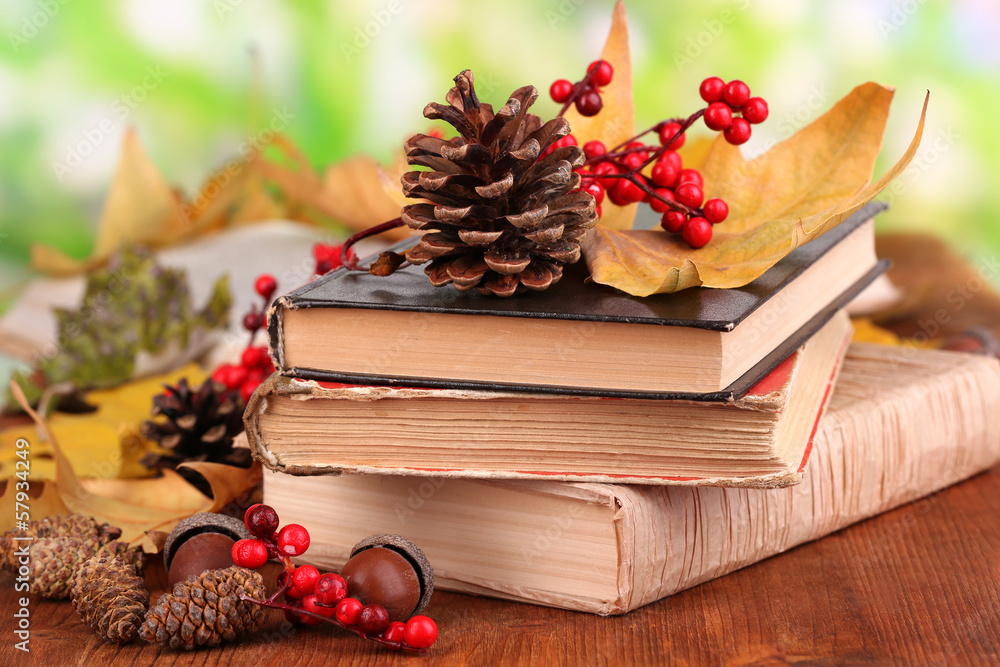 Books and autumn leaves on wooden table on natural background Books and autumn leaves on wooden table on natural background