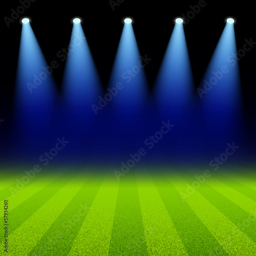 Bright spotlights illuminated green soccer field