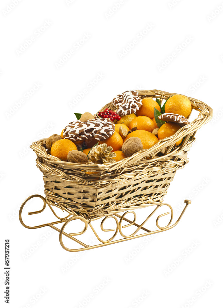 Christmas decorative sledge with fresh clementines and nuts.