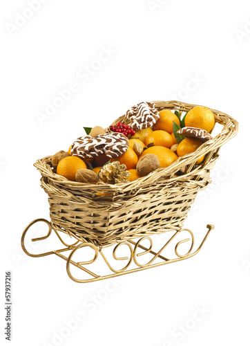 Christmas decorative sledge with fresh clementines and nuts.