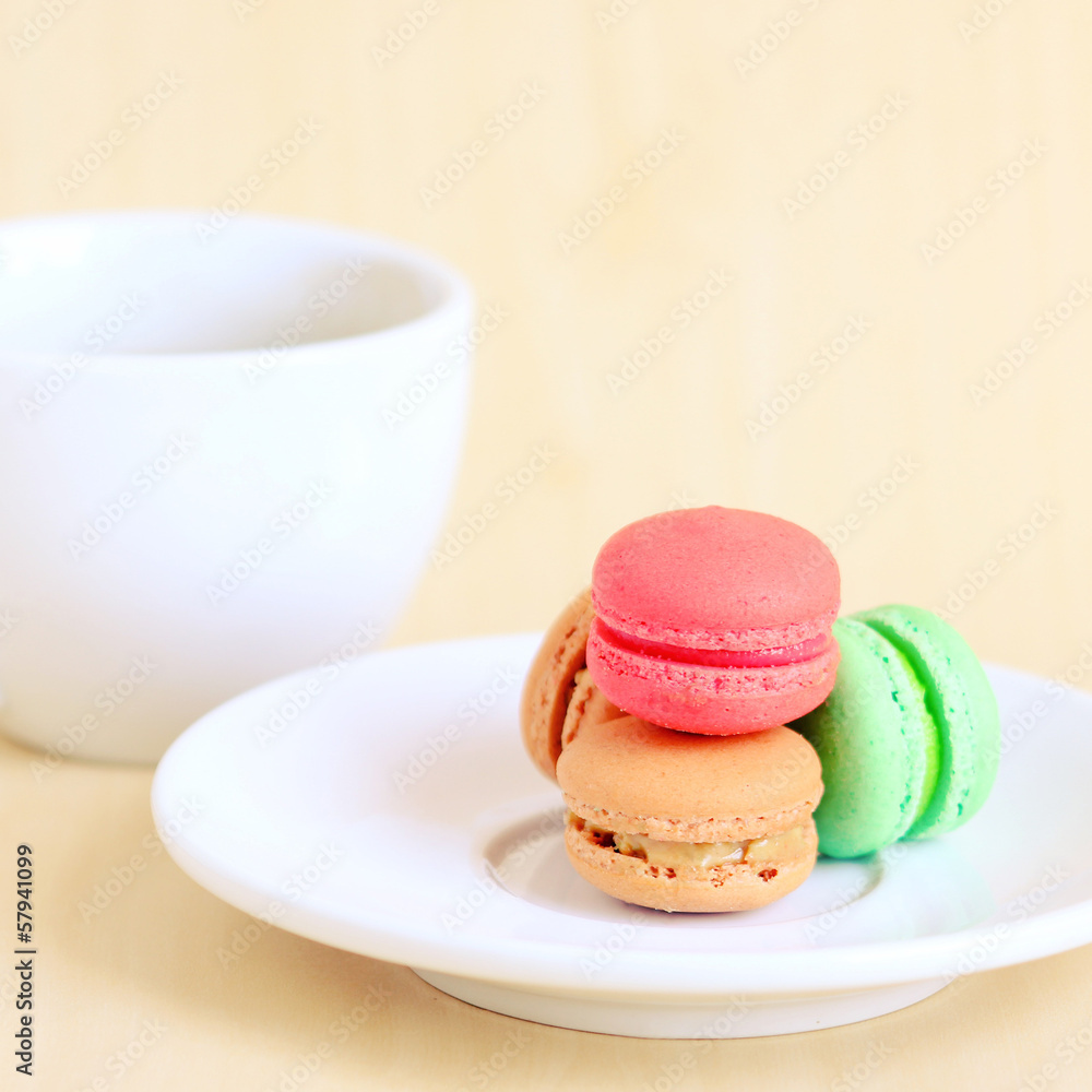 Colorful macaroons and cup of coffee with retro filter effect Colorful macaroons and cup of coffee with retro filter effect