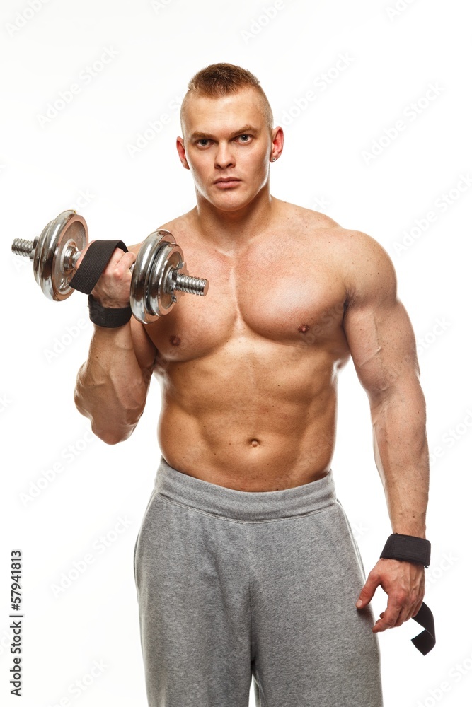 Handsome young muscular man exercising with dumbbells