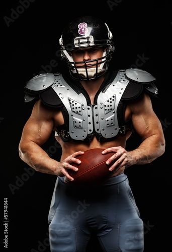 Fototapeta Naklejka Na Ścianę i Meble -  American football player wearing helmet and protective armour