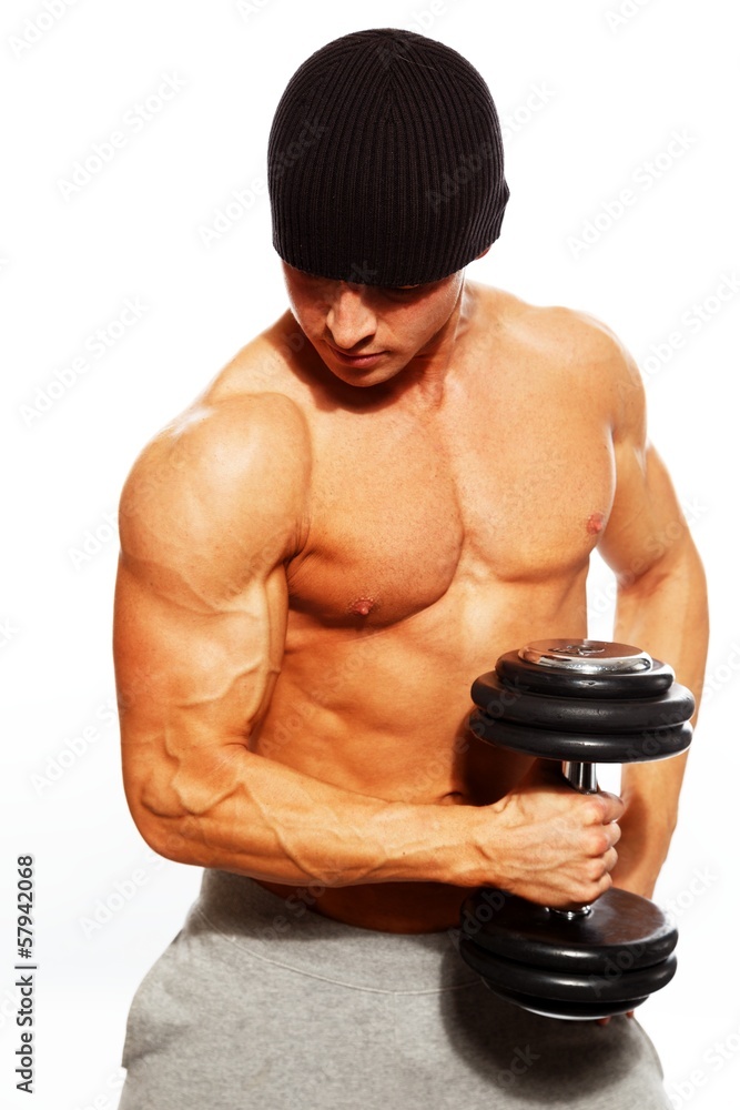 Handsome young muscular man exercising with dumbbells Handsome young muscular man exercising with dumbbells