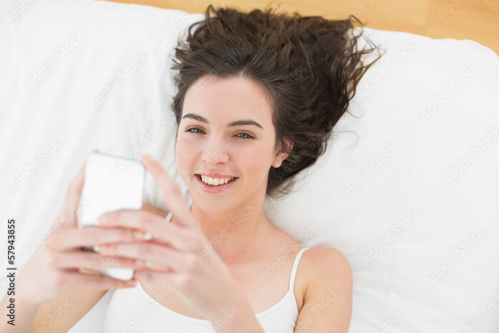 Portrait of relaxed woman text messaging in bed Portrait of relaxed woman text messaging in bed