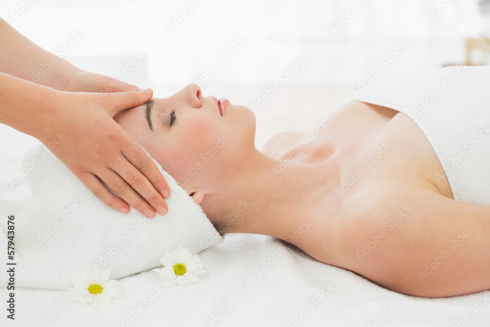 Hands massaging woman's face at beauty spa Hands massaging woman's face at beauty spa