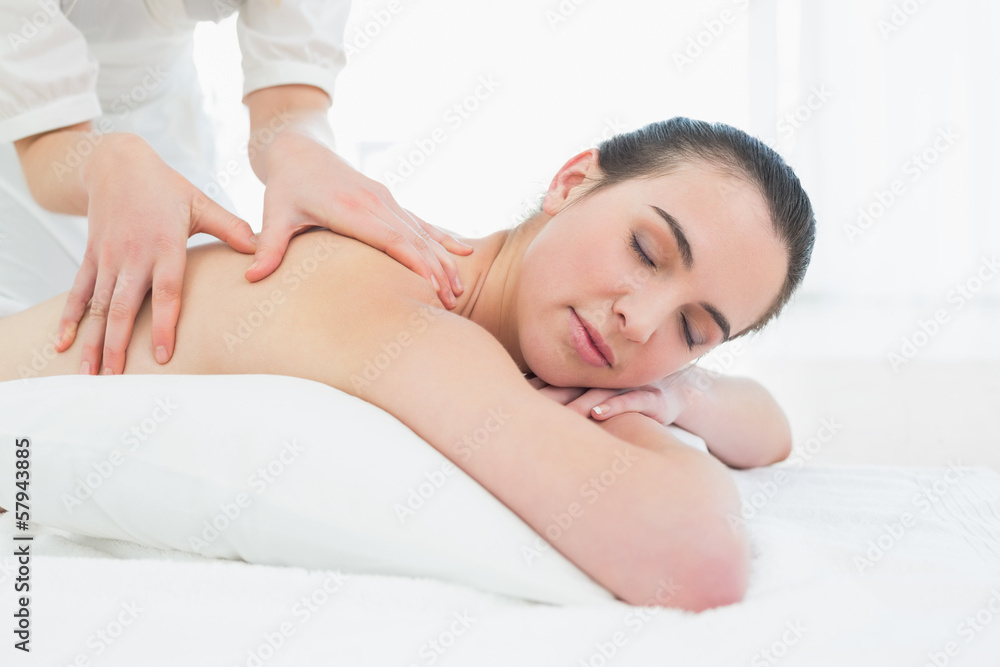 Beautiful woman enjoying back massage at beauty spa