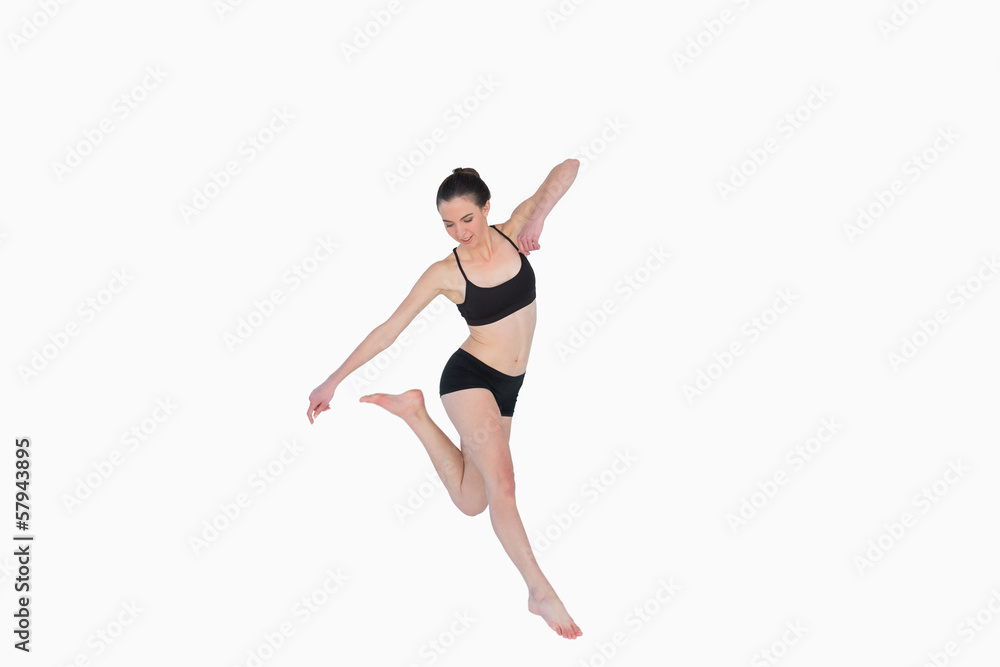 Full length of a sporty young woman jumping Full length of a sporty young woman jumping