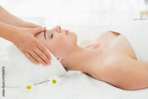 Hands massaging woman s face at beauty spa